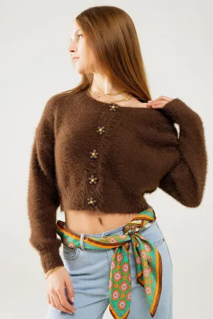 Short and fluffy brown cardigan with flower buttons